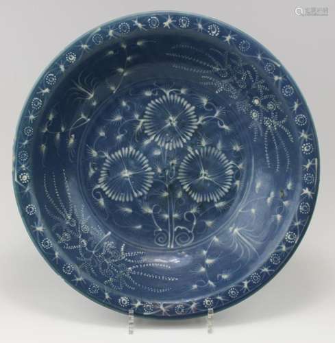 A large blue glaze Swatow dish with slip decoration