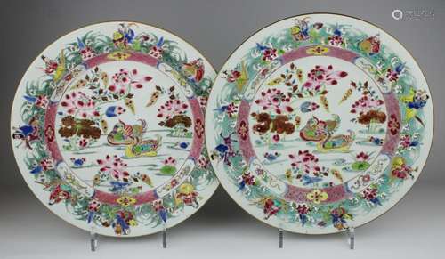 A pair of famille rose chargers with immortals and lotus pon...