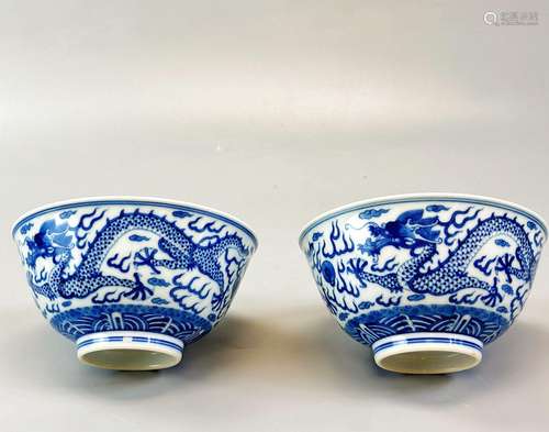 A pair of blue and white dragon bowls, six character marks o...