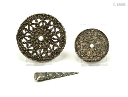 Two silver discs from Sumatra and a silver brooch