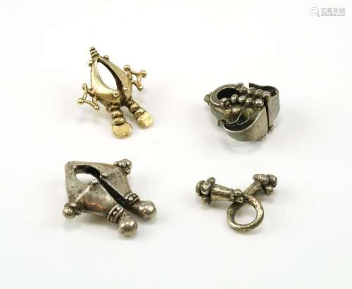 Three silver and one gold earring from Indonesia