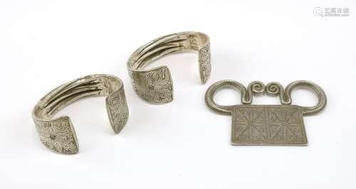 A pair of silver bracelets and a silver pendant from the Mia...