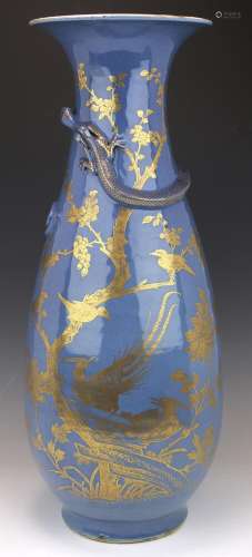 A tall powder blue and gilt vase with dragon relief