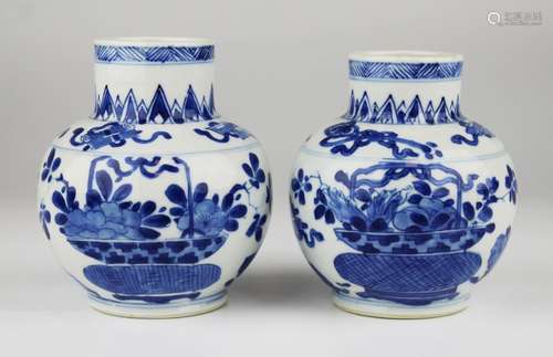 A pair of blue and white flower basket vases