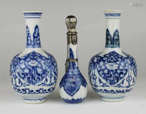 A pair of blue and white vases and a scent bottle