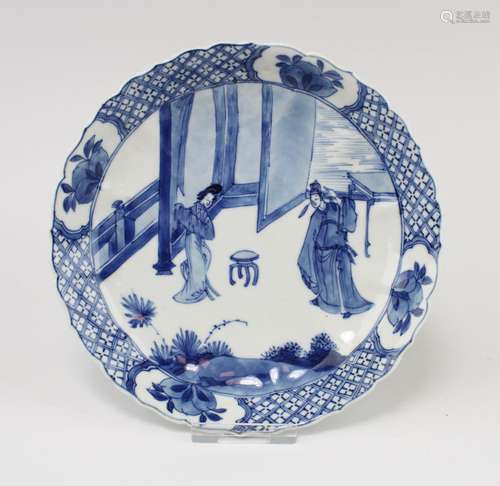 A small blue and white plate with figures