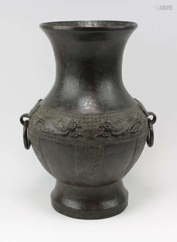 A Hu bronze vase with taotie masks as ring handles