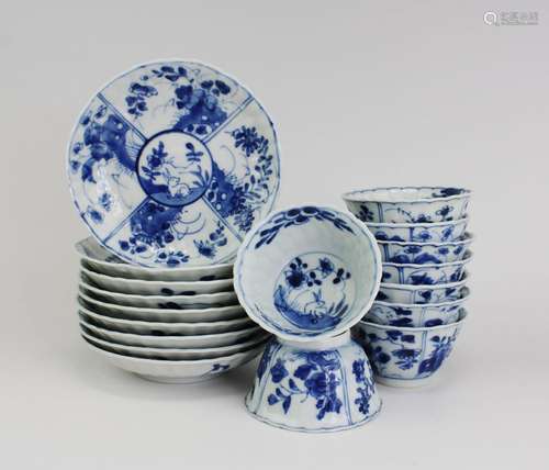 Nine blue and white cups and saucers