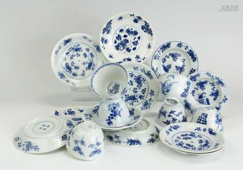 Six blue and white cups and eleven saucers with floral decor...