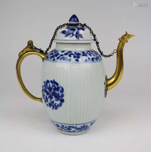 A blue and white teapot with gilt metal spout and handle
