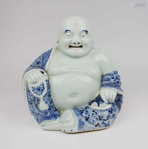 A blue and white laughing Buddha