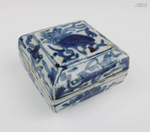 A small square lidded blue and white box