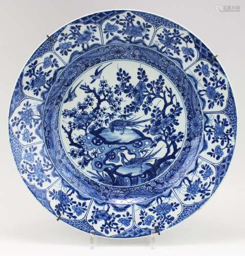 A blue and white charger with birds and florals