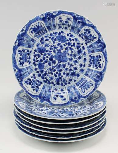 Seven blue and white plates, scattered flowers