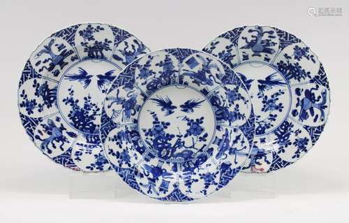 Three large blue and white plates