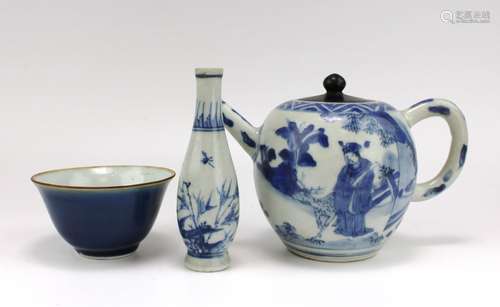 A blue and white teapot with a vase and bowl from the Hatche...