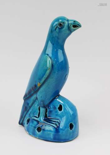 A turquoise glazed parrot