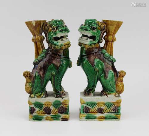 A pair of figural foo-dogs sancai biscuit-ware joss stick ho...