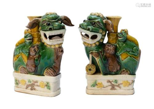 A pair of figural foo-dogs sancai biscuit-ware joss stick ho...