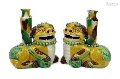 A pair of figural foo-dogs sancai biscuit-ware joss stick ho...