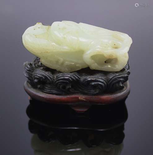 A pale celadon jade carving of a bug on a double aubergine o...