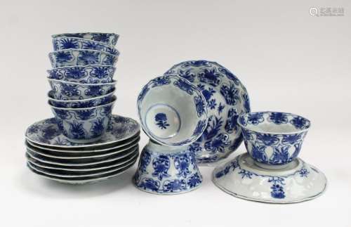 Nine blue and white cups and saucers
