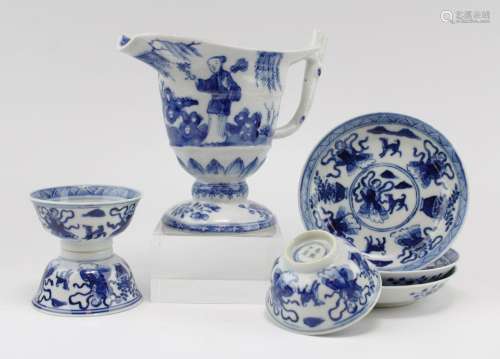 Three blue and white cups and saucers and a creamer