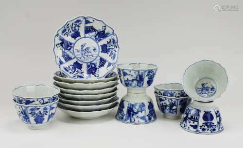 Eight blue and white cups and saucers