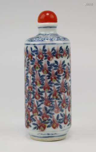 A blue and white snuff bottle with underglaze copper red