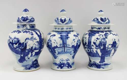 Three blue and white covered vases