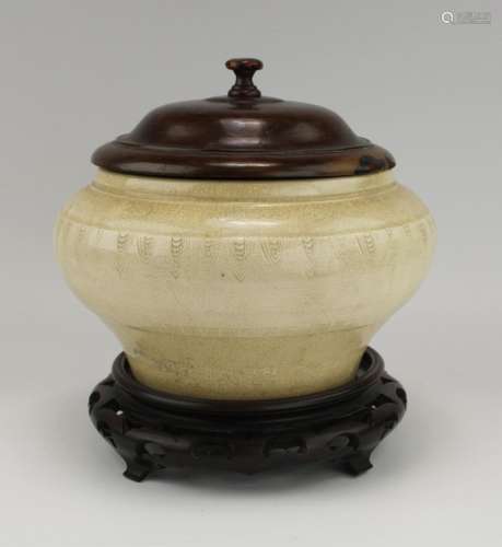 A creamy-coloured pottery censer with wooden cover and base