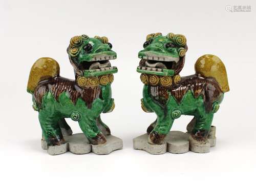 A pair of foo-dog sancai biscuit-ware figures