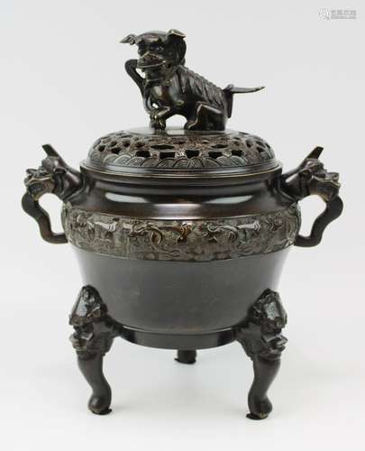 A bronze tripod censer