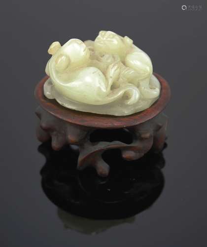 A pale celadon jade carving of two squirrels on a lotus leaf