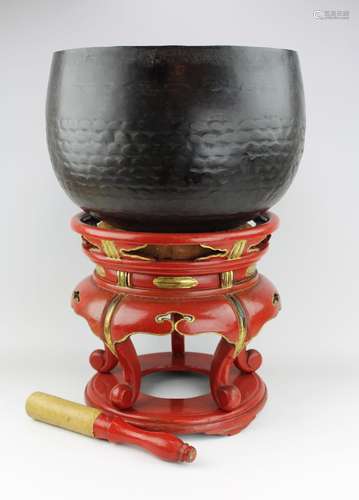 A Japanese temple bell on red lacquer stand