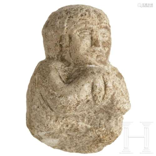 A Near Eastern limestone fragment of an offering person, 1st...