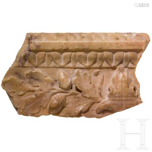 A Roman fragment of a marble frieze with bucranium and oak b...