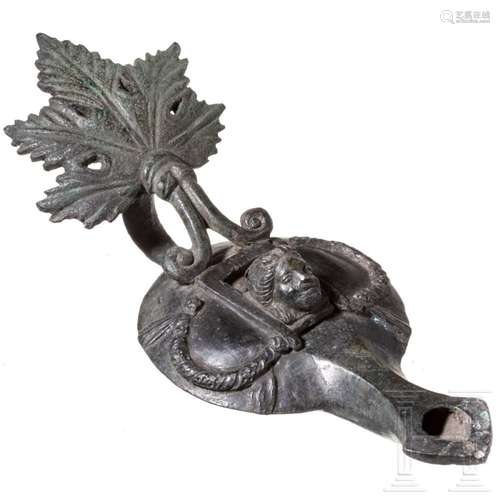 A Roman bronze oil lamp, 1st century A.D.