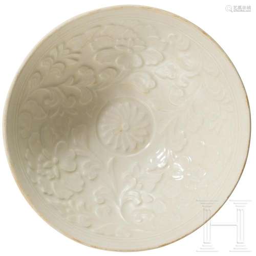 A Ding bowl with cream-coloured glaze and moulded flower des...