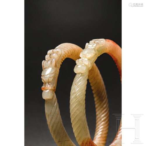 A pair of Chinese celadon jade dragon bangles, 20th century