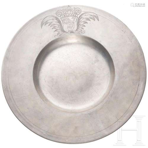 A large Tyrolean pewter broad-rim charger with engraved cres...