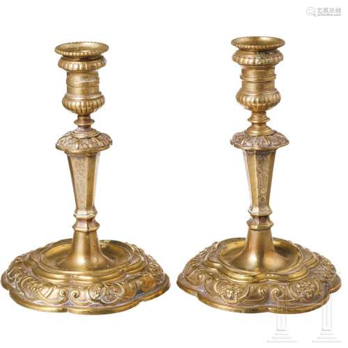 A pair of German brass Louis XV candlesticks, circa 1720