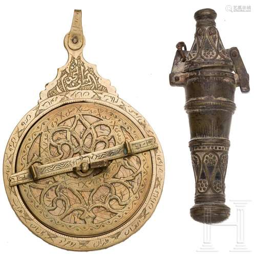 A brass astrolabe and a bronze limestone vessel, Persian (Ir...