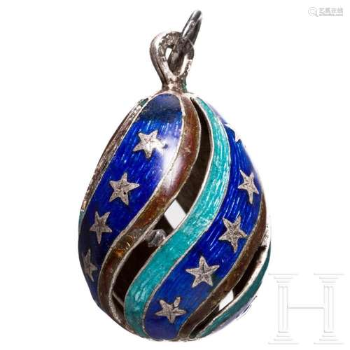 A silver and enamel egg pendant