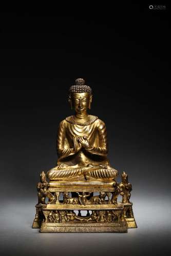 A CHINESE GILT-BRONZE FIGURE OF BUDDA