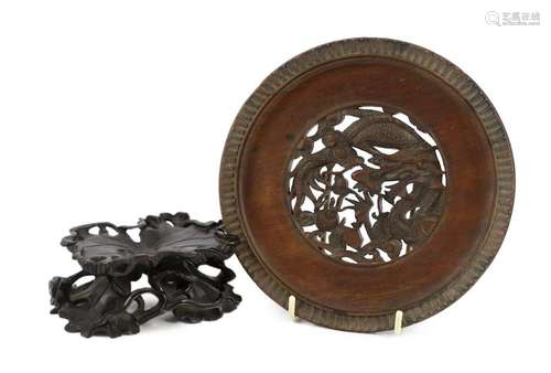 A Chinese carved wood ‘lotus’ stand and a Chinese huanghuali...