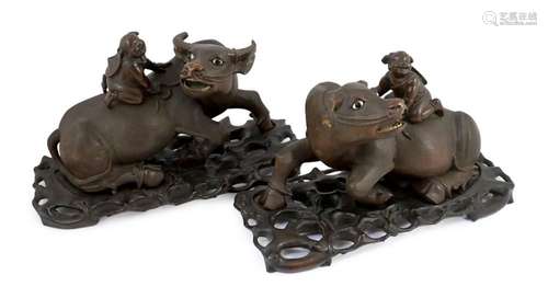 A pair of large Chinese carved hardwood buffalo groups, earl...