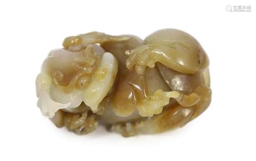 A Chinese white and brown jade lion-dog carving