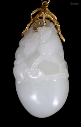 A Chinese white jade ‘conch shell’ yellow metal mounted pend...