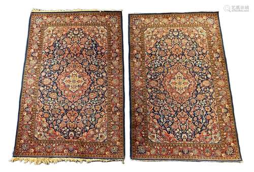 A pair of Kashan blue ground rugs, 213 x 139cm